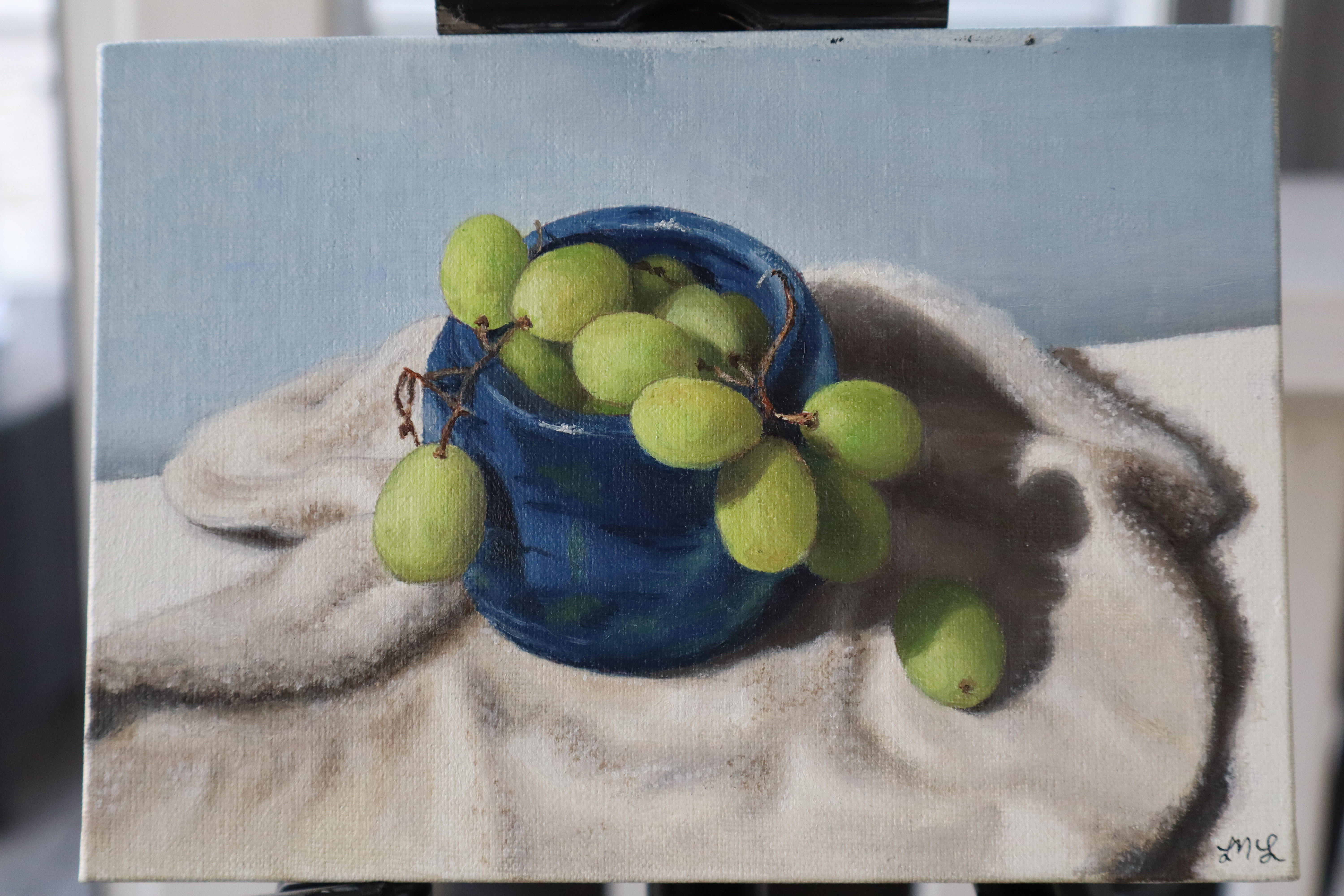 Still life — green grapes in a blue bowl